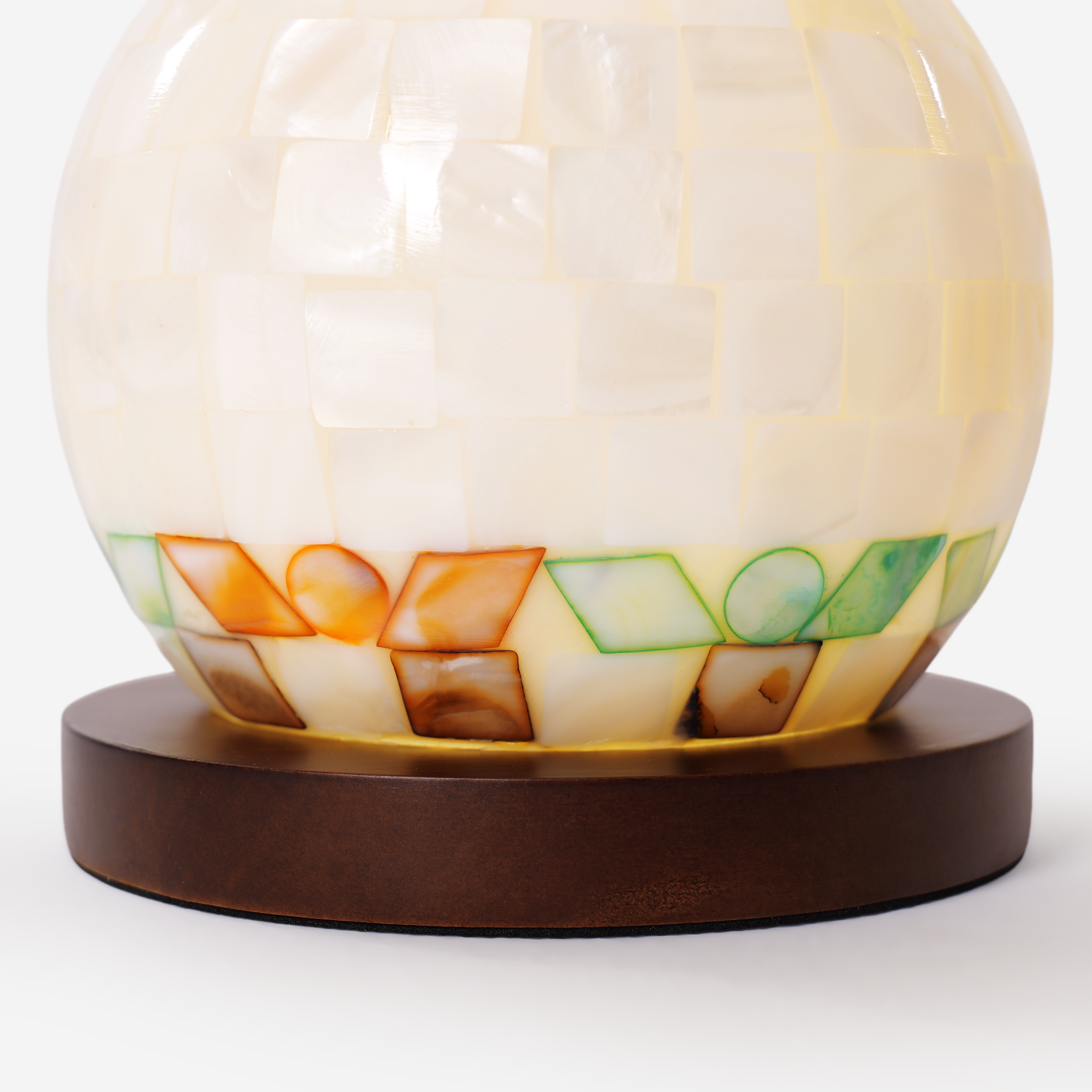 mother-of-pearl mosaic table lamp adding warm light to a bedroom