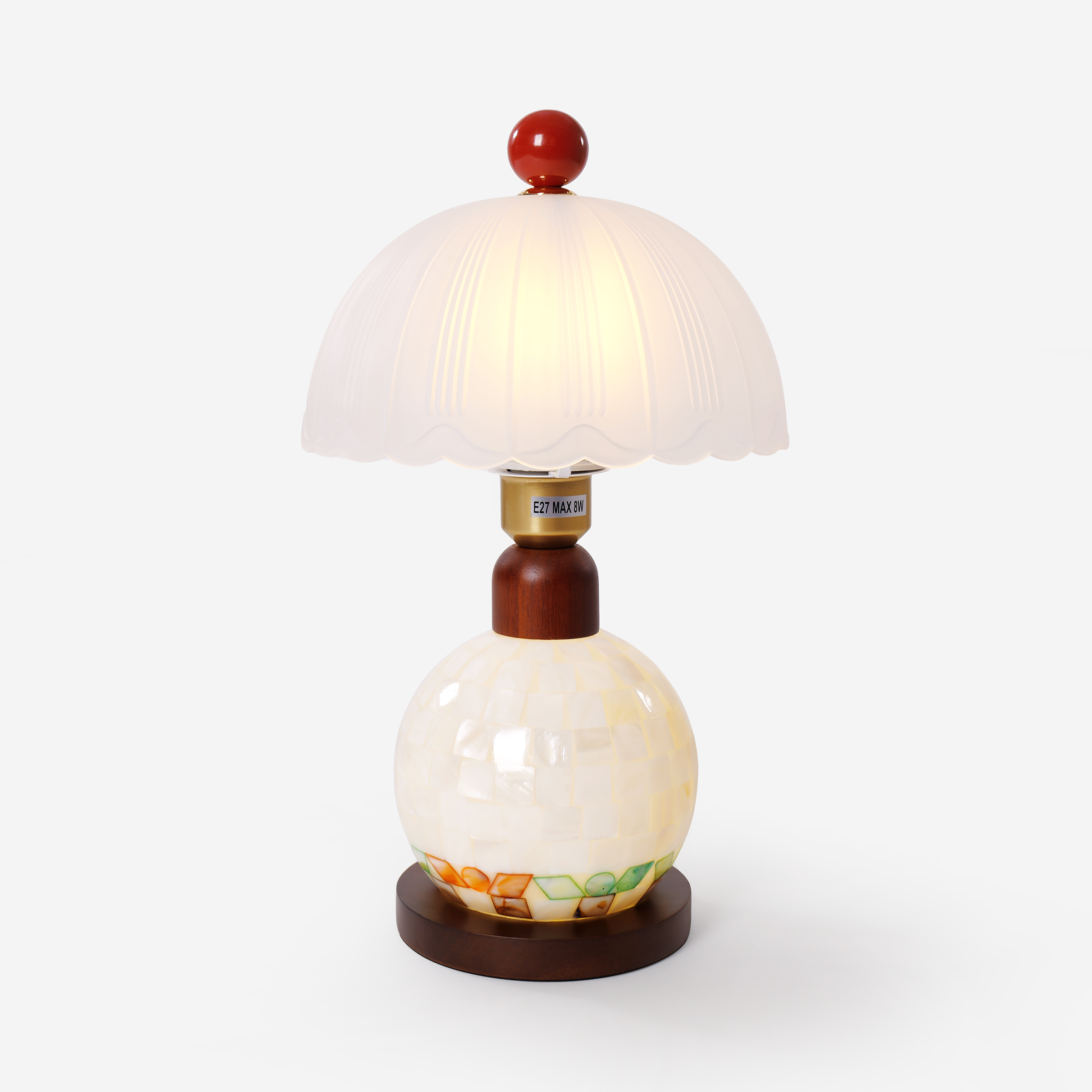 mother-of-pearl mosaic table lamp on a desk with soft ambient light