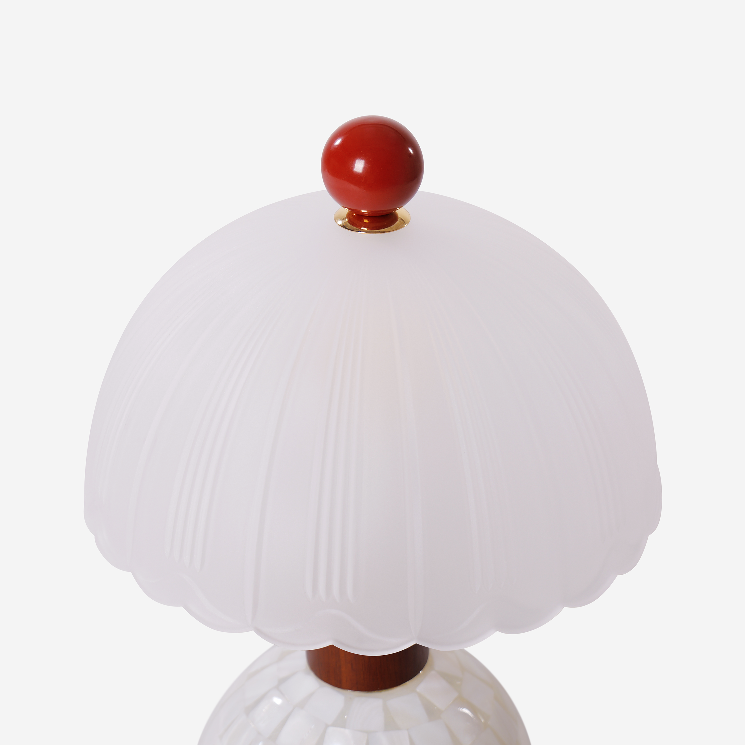 mother-of-pearl mosaic table lamp beside books and evening decor