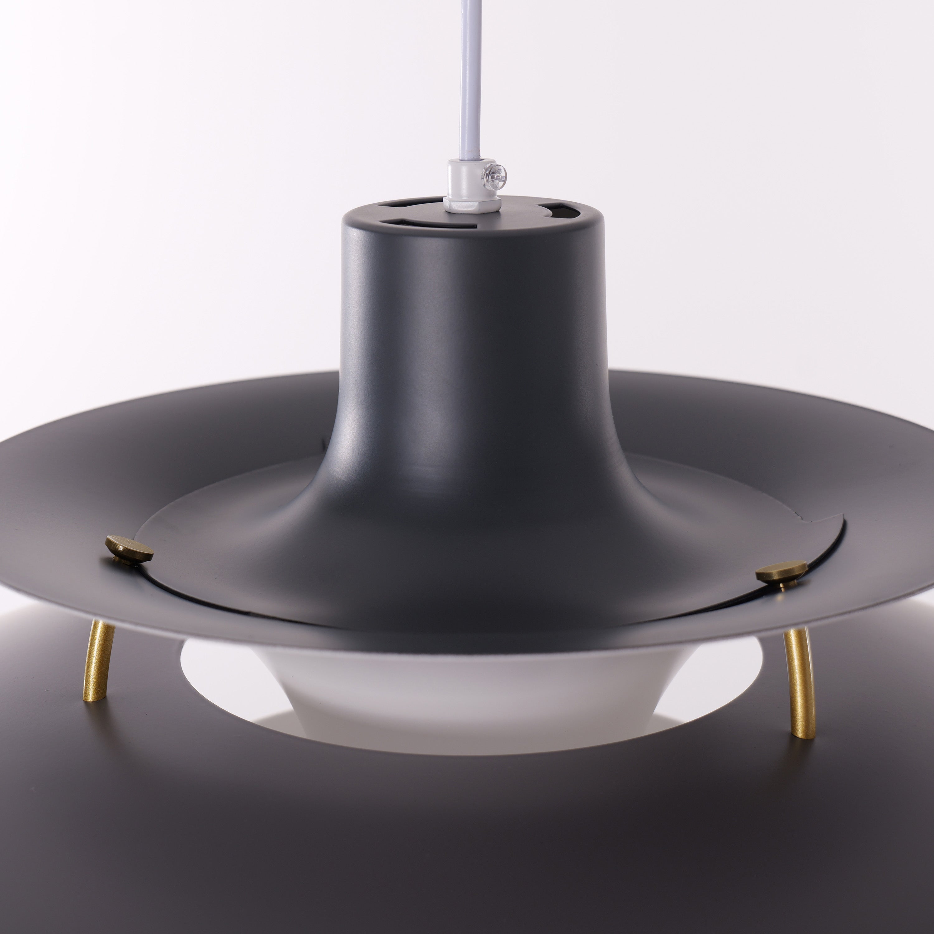 white layered minimalist pendant light hung above a dining table