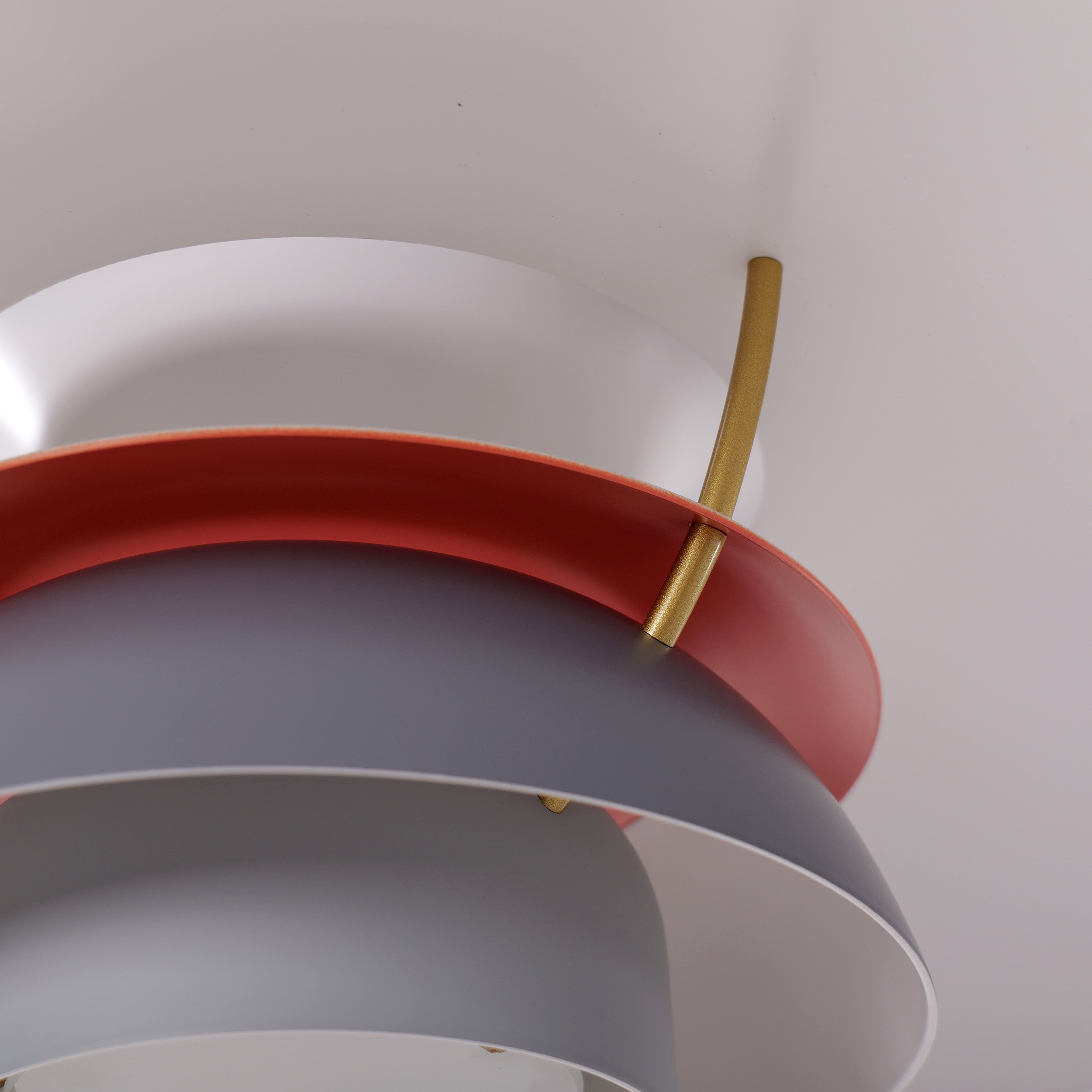 white layered minimalist pendant light styled in a calm bedroom