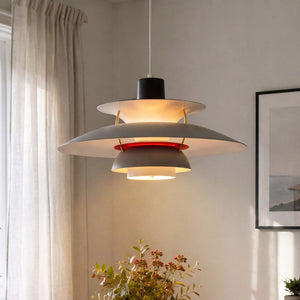 white layered minimalist pendant light hung above a dining table