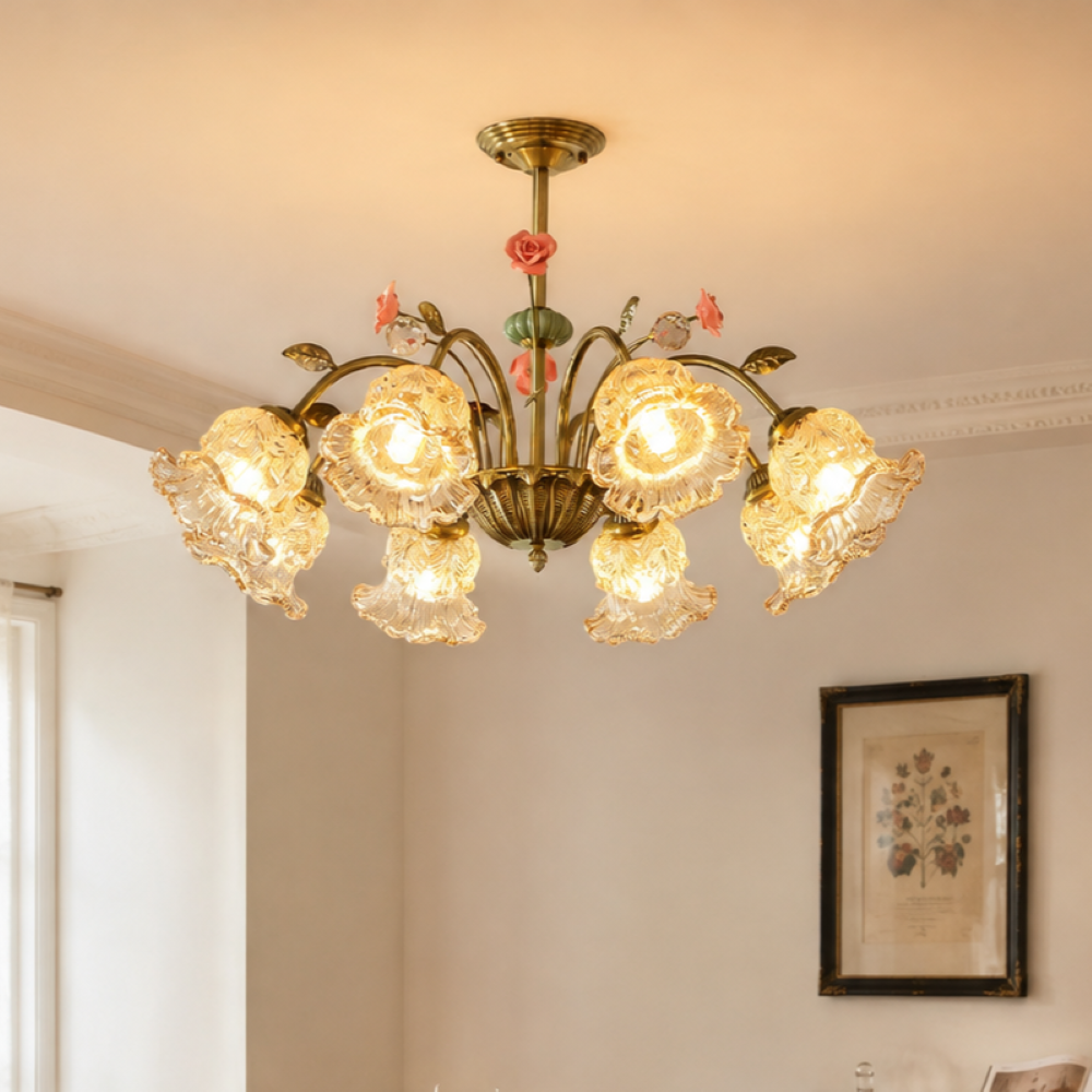 gold 8-light chandelier with pink floral glass shades glowing above a dining table