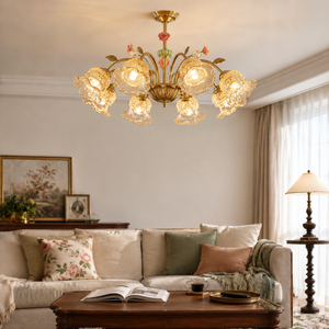 gold 8-light chandelier with pink floral glass shades adding soft light to a bedroom