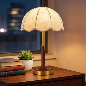 Vintage floral fabric table lamp in a walnut tone with a scalloped cream shade