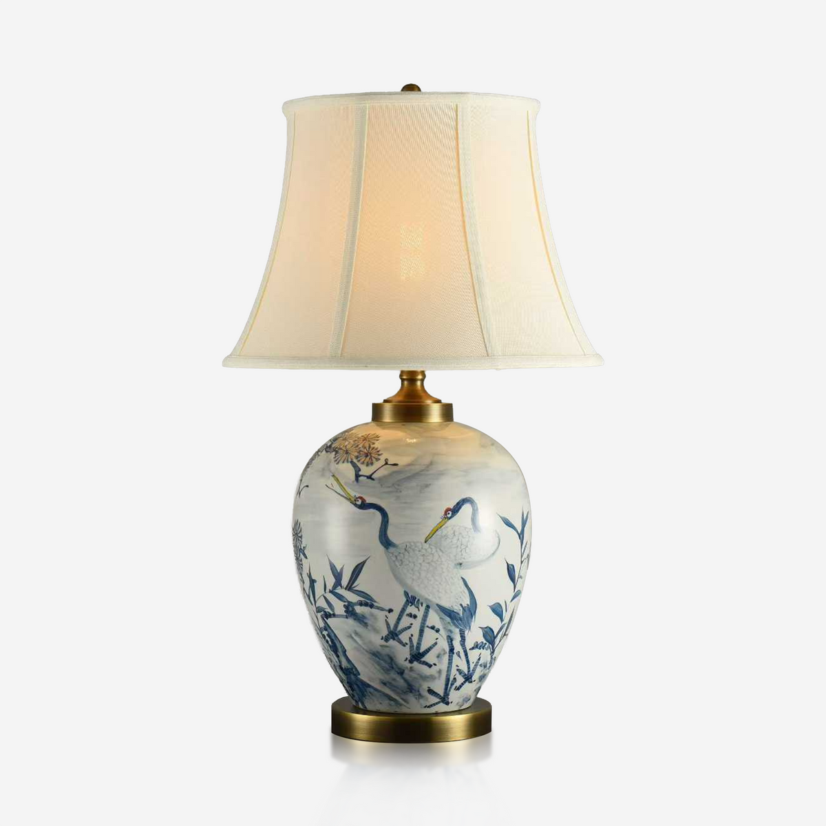 Blue and white crane ceramic lamp with curved ivory fabric shade