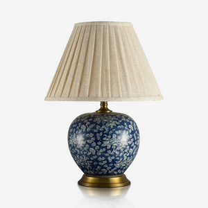 Navy floral ceramic table lamp with rounded base and pleated ivory shade