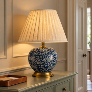 Navy floral ceramic lamp lighting a hallway console table