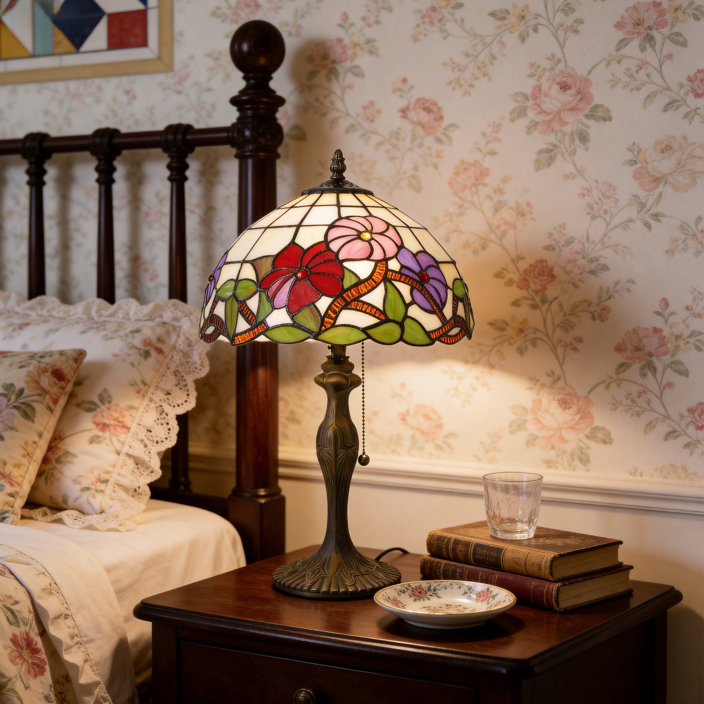 Red, pink and purple Tiffany table lamp glowing on a vintage bedroom bedside table